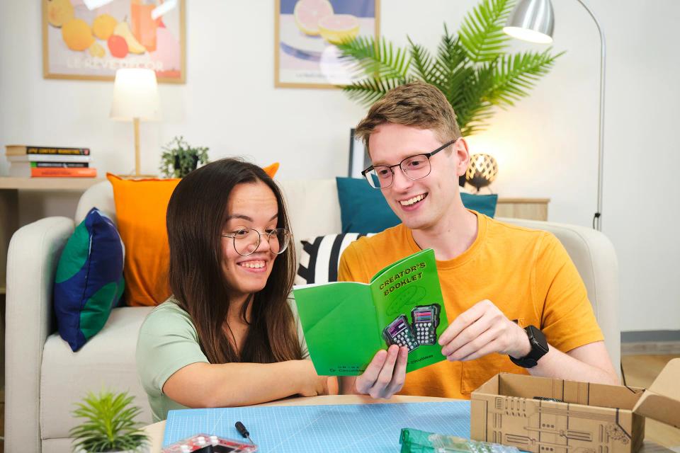 Two person reading Chatter 2.0 booklet