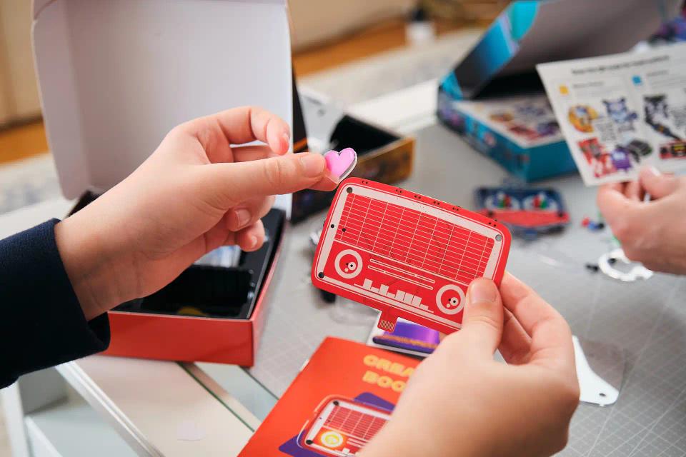 A person playing with CircuitMess Hertz stickers
