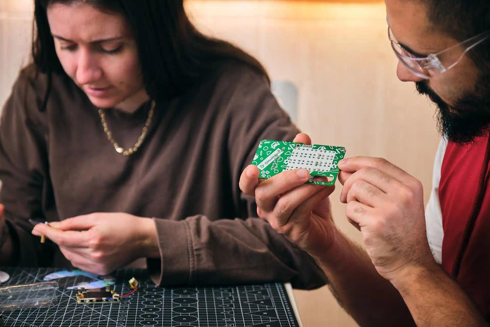 A woman and man assembling CircuitMess Chatter