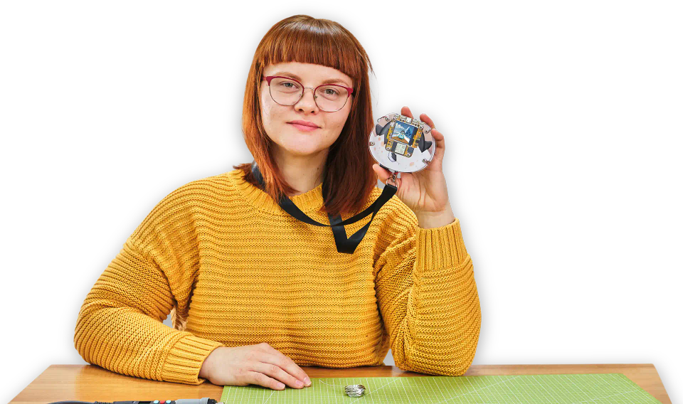 A woman playing with CircuitMess Codee