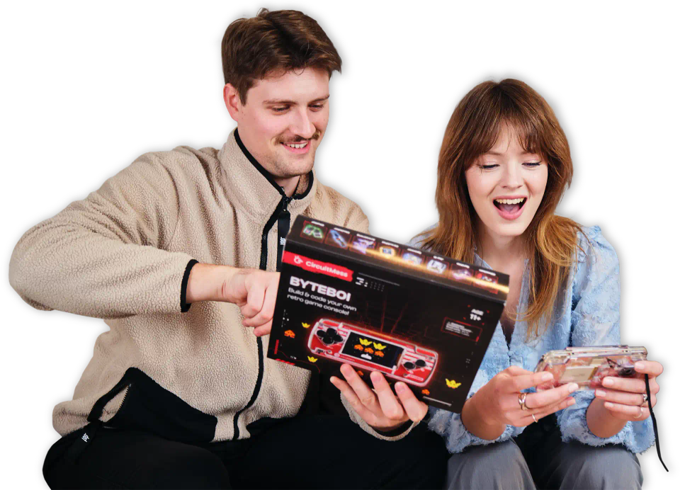 Two people playing with CircuitMess ByteBoi