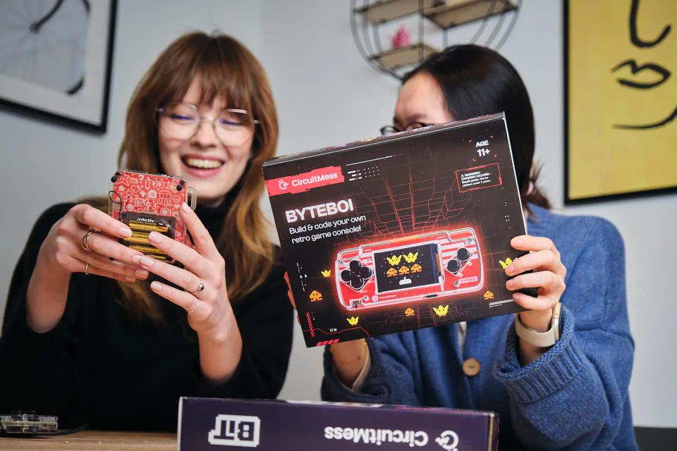Two girls holding CircuitMess Bit and ByteBoi