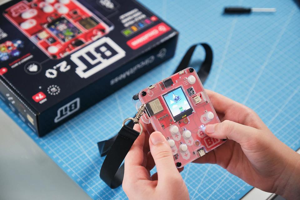 A person playing arcade games on CircuitMess Bit