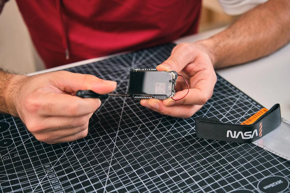 A man assembling CircuitMess NASA Artemis Watch