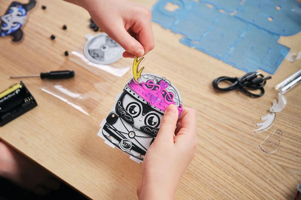 A person playing with CircuitMess Harald stickers