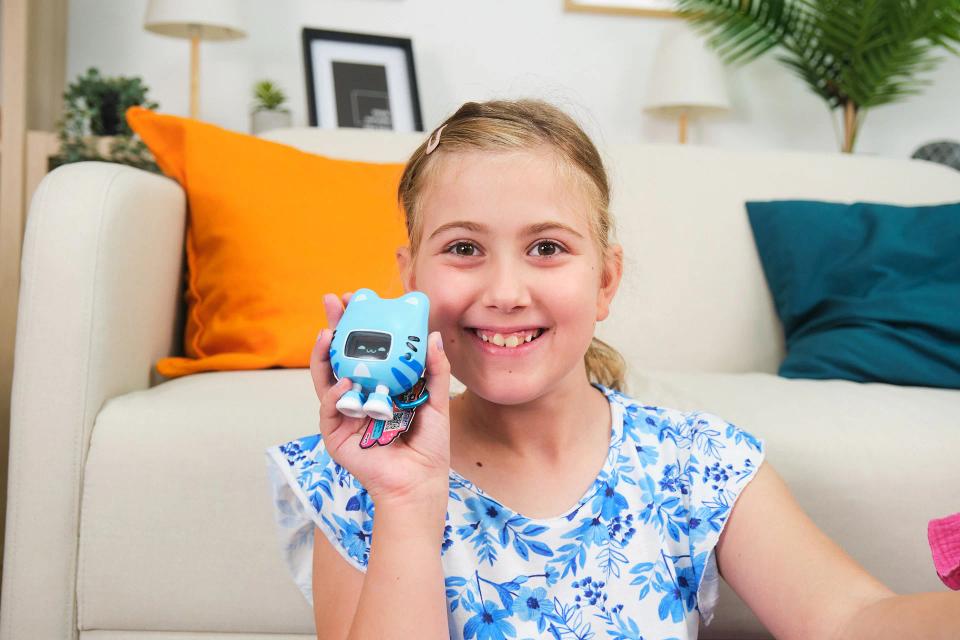 A girl playing with CircuitMess Beep Boop Miao Miao.