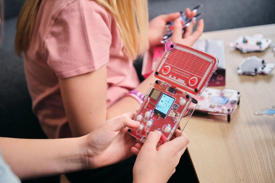 A person playing a CircuitMess Bit game unlocked by Hertz