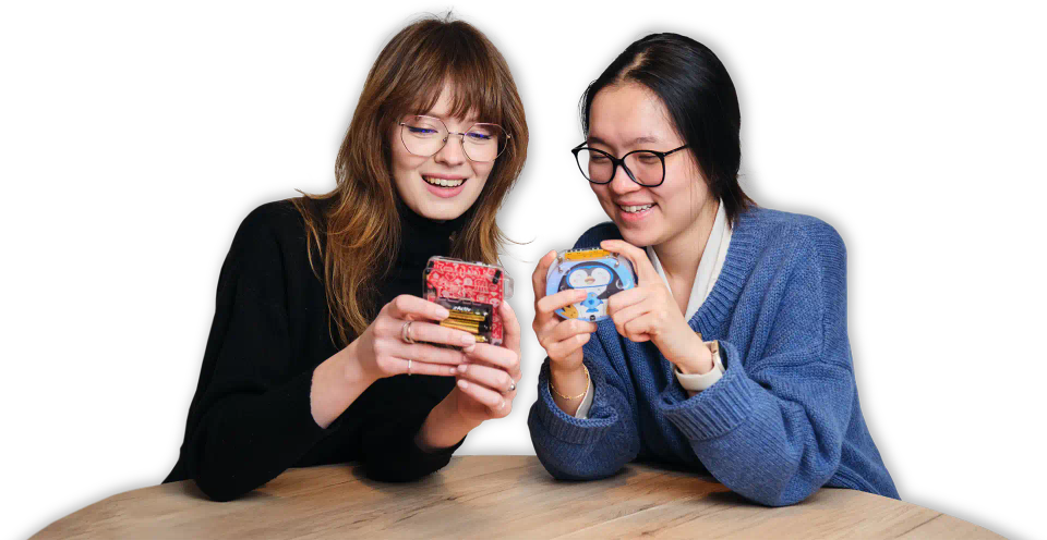 Two women playing with CircuitMess Codee and Bit