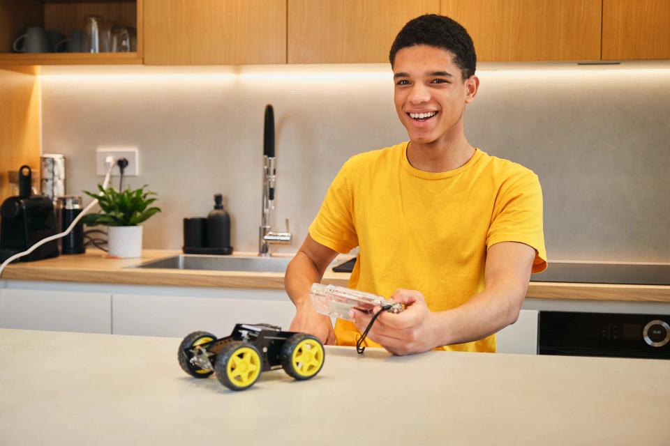 A man controlling CircuitMess Wheelson with ByteBoi