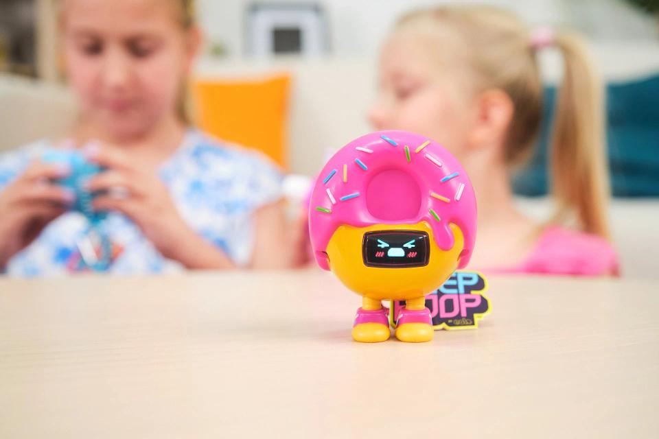 CircuitMess Beep Boop Mochi on a table with two girls in the background.