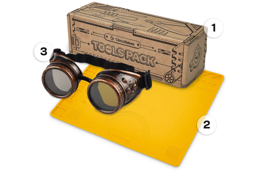 CircuitMess tools, silicon work mat and protective goggles on a transparent background