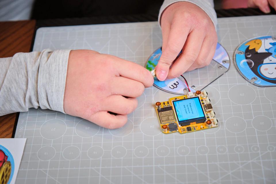 A person assembling CircuitMess Codee on a Silicone Work Mat
