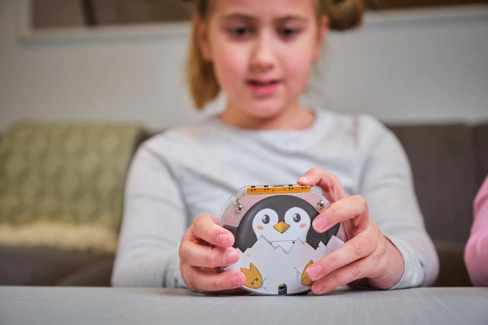 A girl playing with CircuitMess Codee