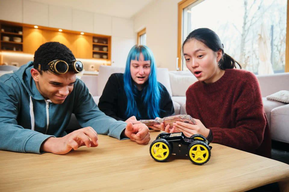 A group of people controlling CircuitMess Wheelson with ByteBoi