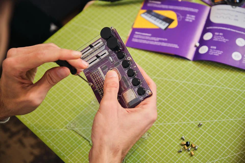 A person assembling CircuitMess Synthia