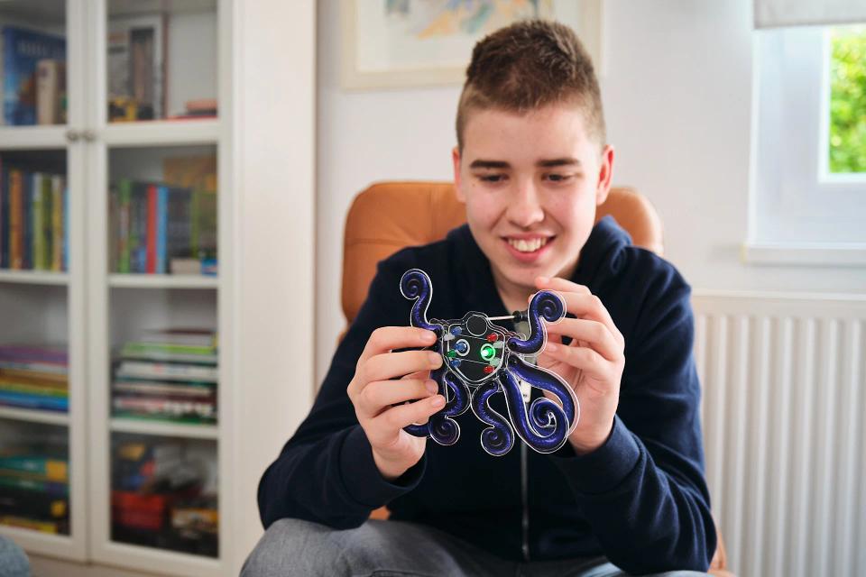 A boy playing with CircuitMess Artemis