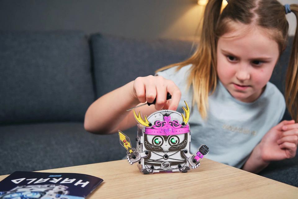 A girl playing with CircuitMess Harald