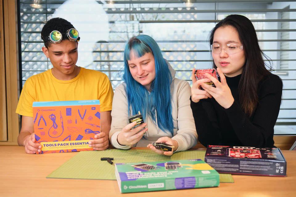 A group of people playing with CircuitMess Chatter and Bit