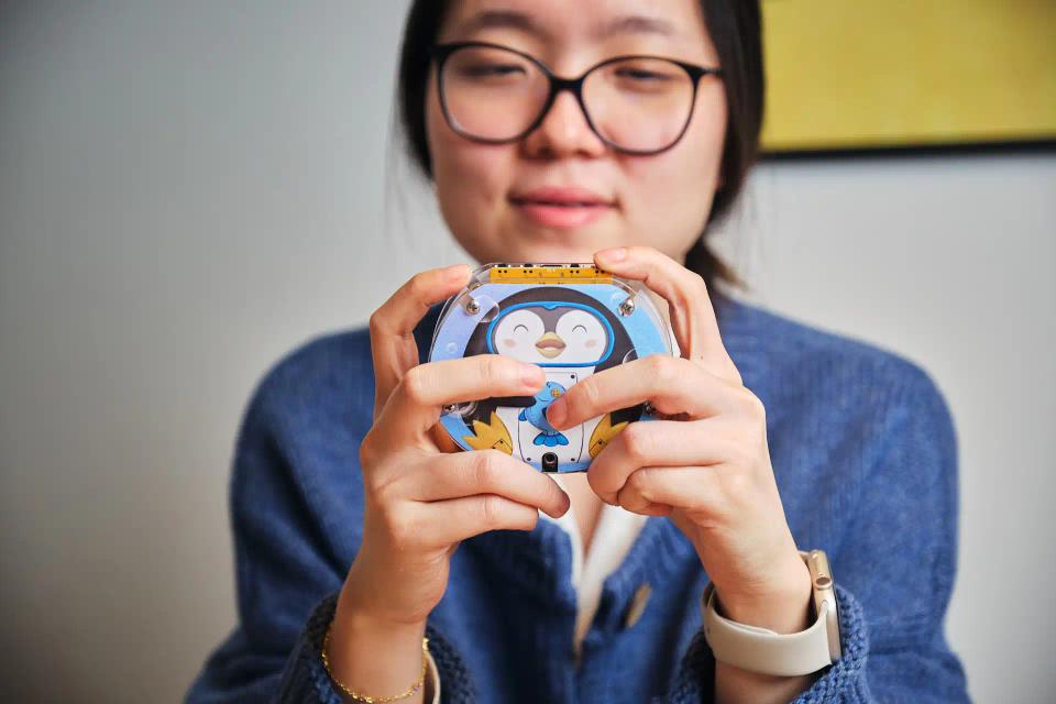 A woman playing with CircuitMess Codee