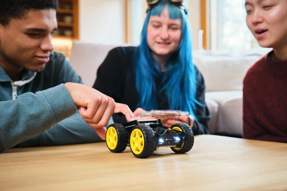 A group of people controlling CircuitMess Wheelson with ByteBoi