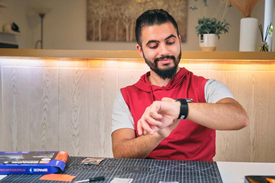 A man playing with CircuitMess NASA Artemis Watch