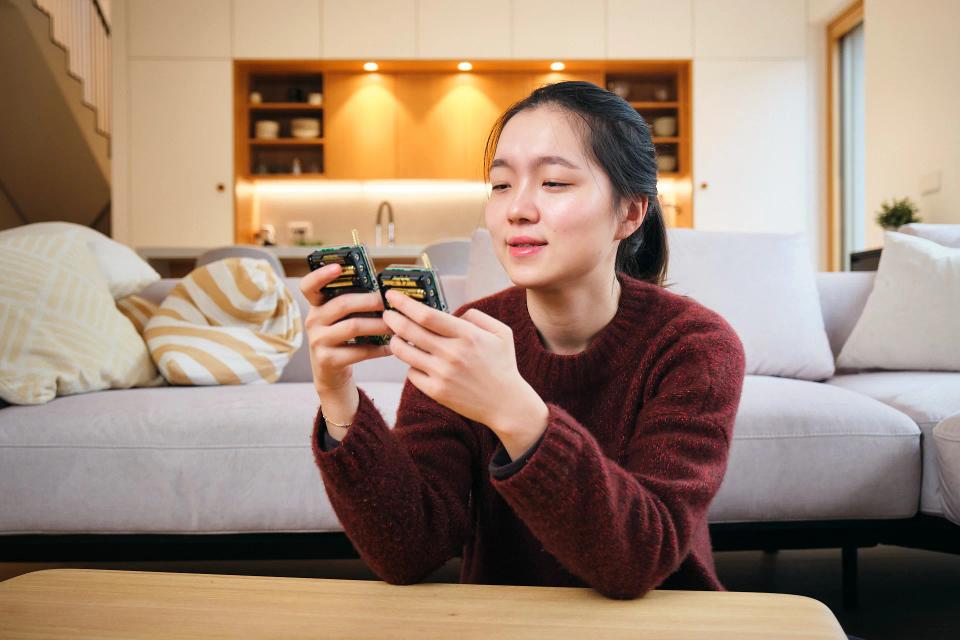 A woman playing with CircuitMess Chatter