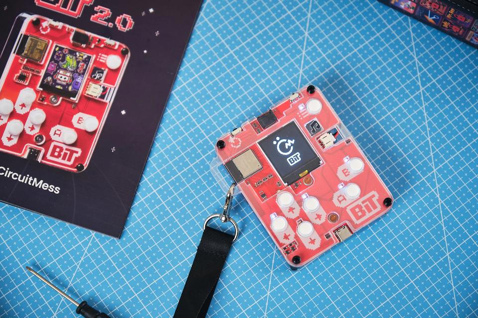 CircuitMess Bit next to its packaging, on a Silicone Work Mat