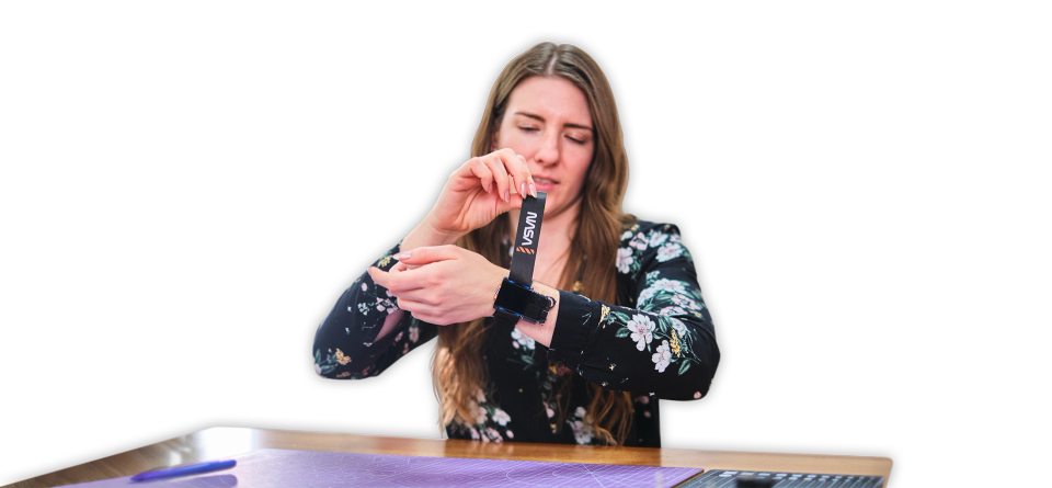 A woman putting on CircuitMess NASA Artemis Watch