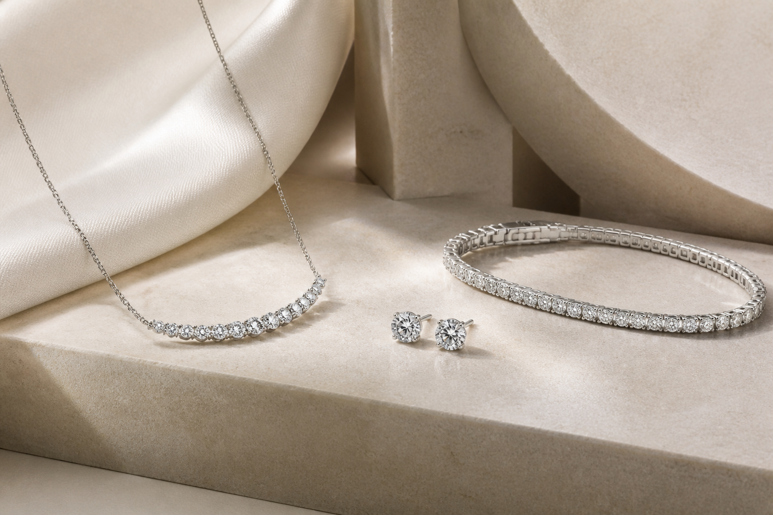 Editorial composition of a diamond necklace, earrings and bracelet on ivory stone