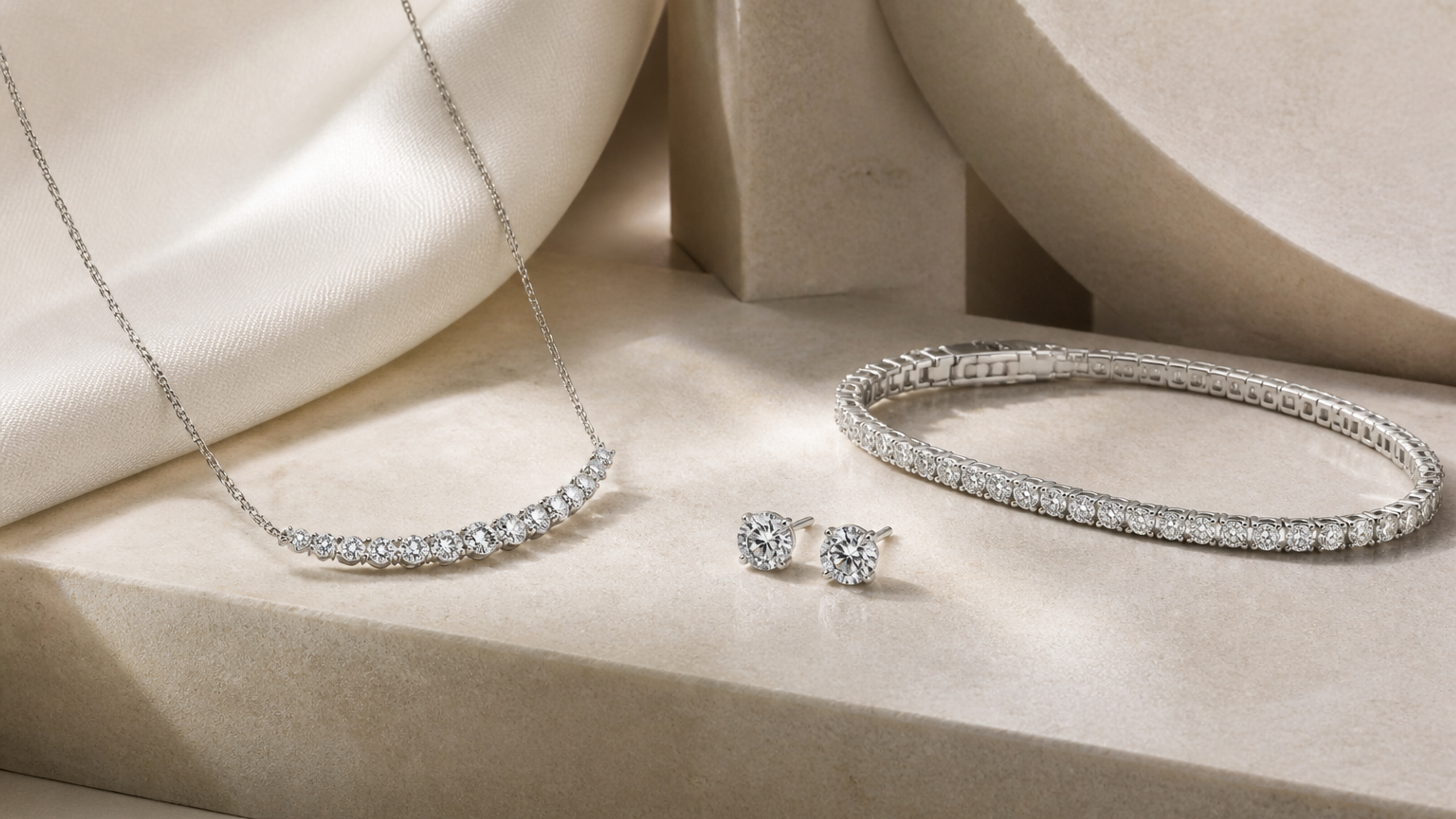 Editorial composition of a diamond necklace, earrings and bracelet on ivory stone