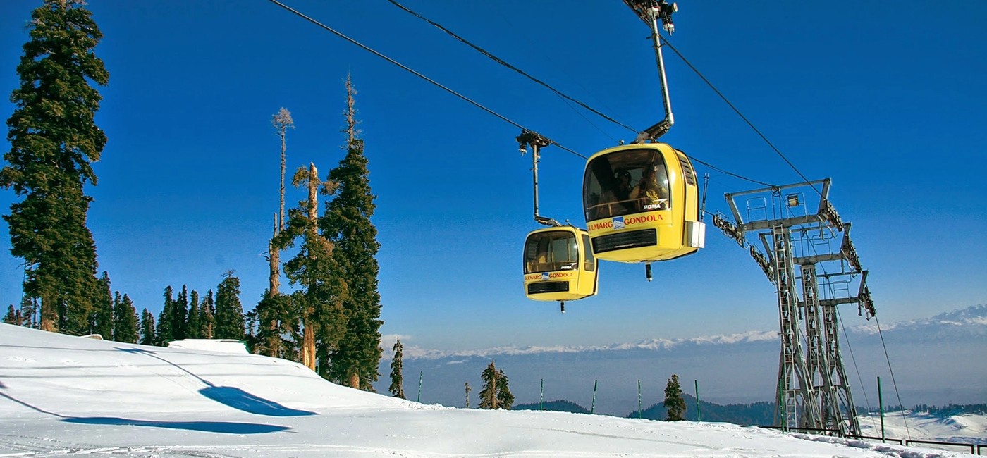 Gulmarg Gondola cable car in Kashmir with snow-covered Apharwat Mountain, one of the top attractions to visit in Gulmarg.