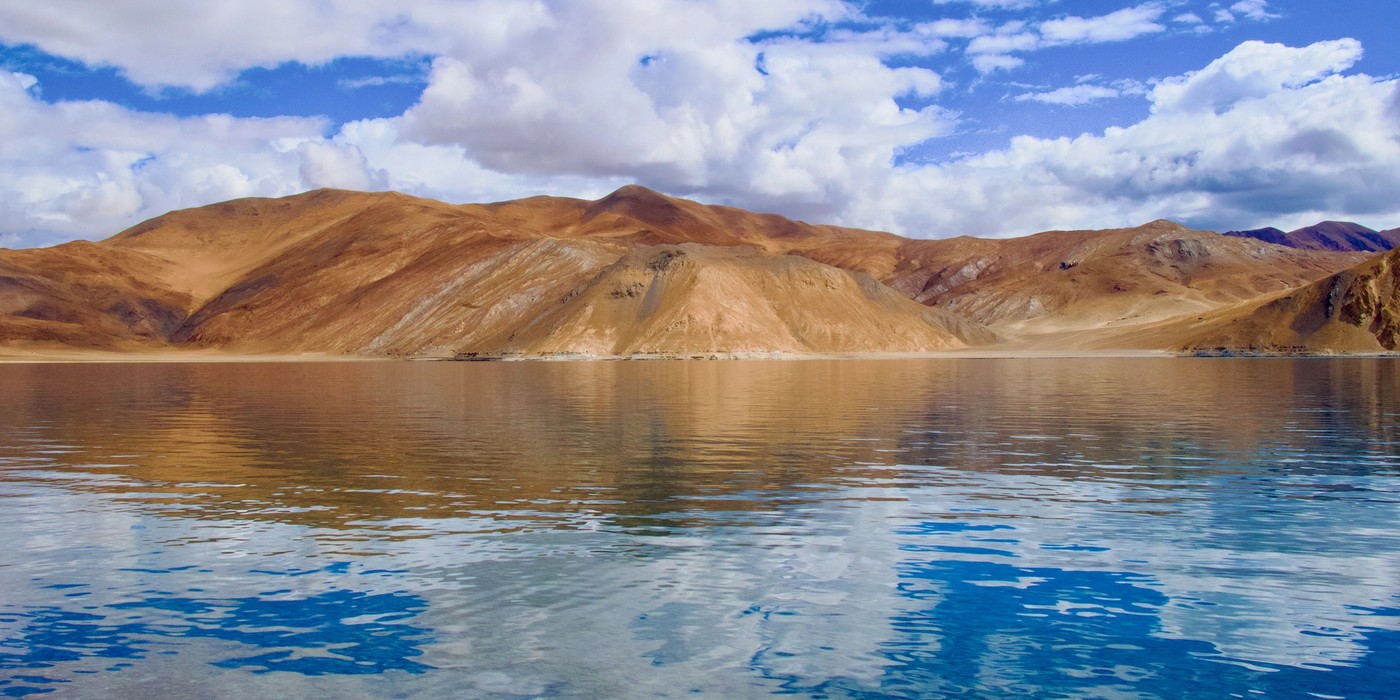 Blue waters of Pangong Lake surrounded by mountains in Ladakh