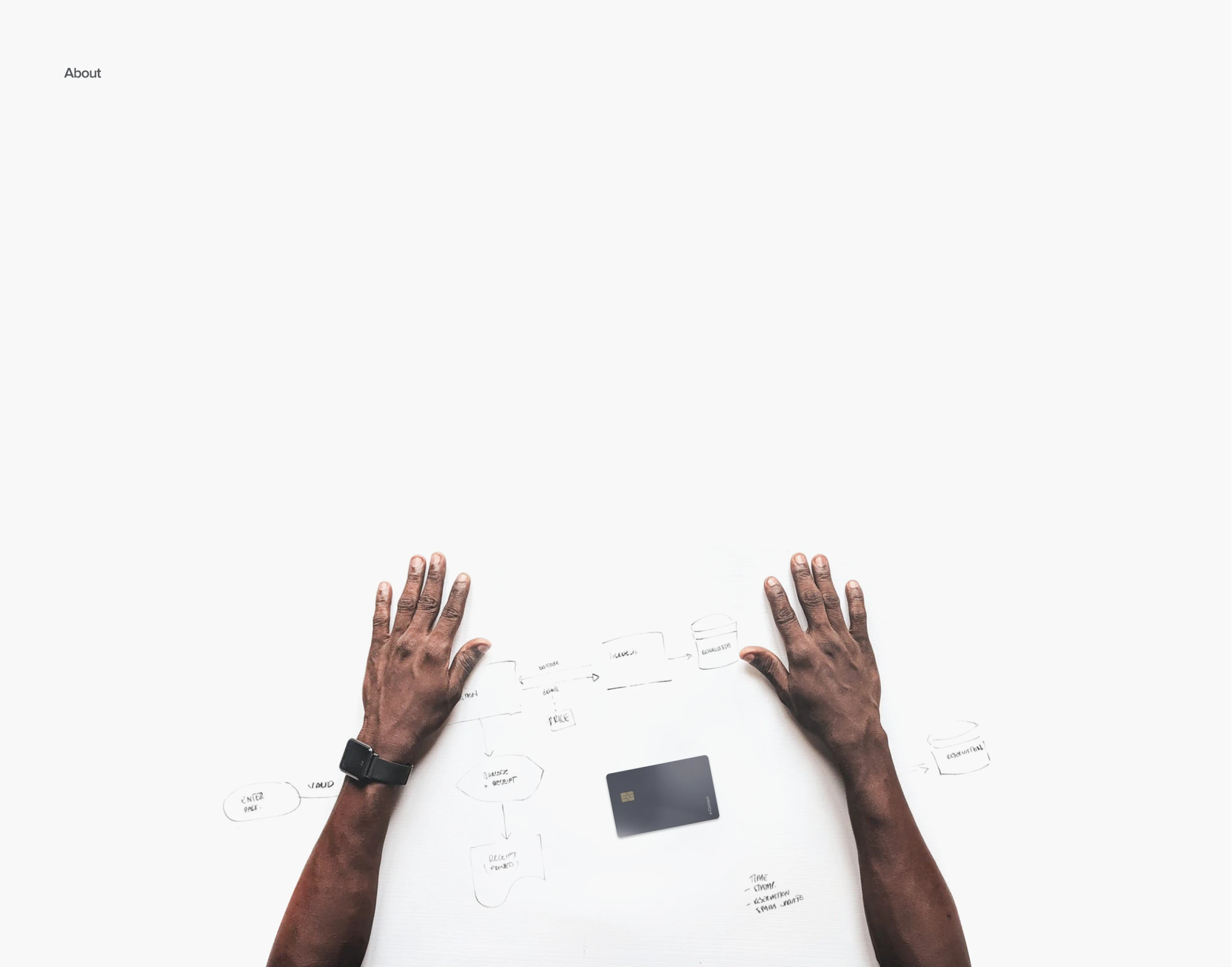 Hands on a desk with an ID card and sketches
