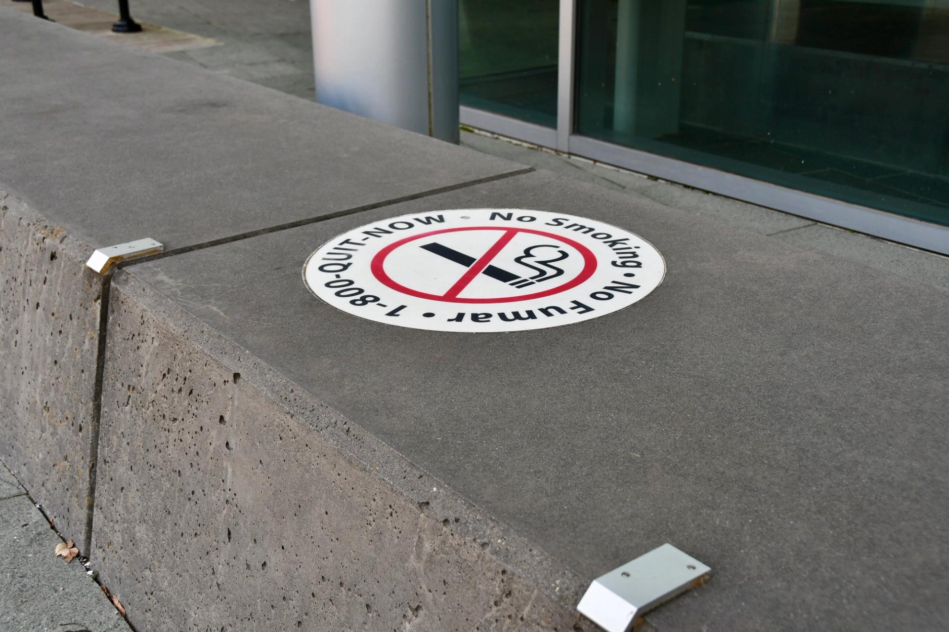 A "no smoking" signs marks a bench outside the public health department.