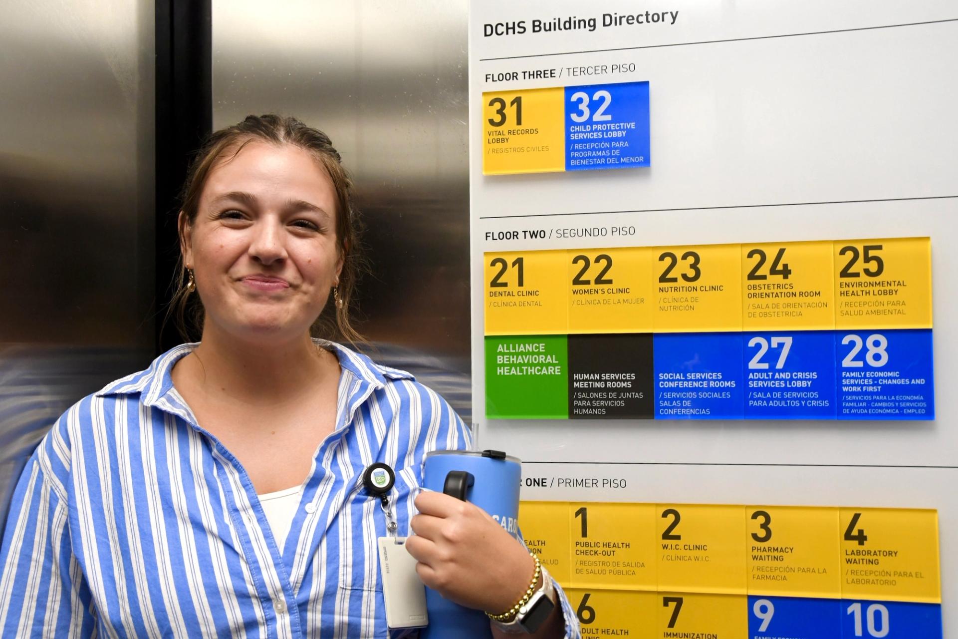 Emma Llewelyn smiles while riding the elevator.