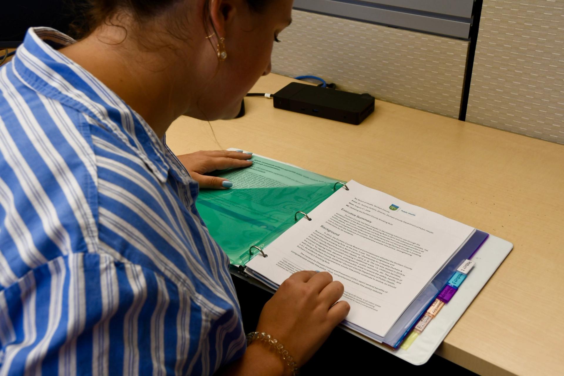 Emma Llewelyn reviews a binder with details of her proposal.