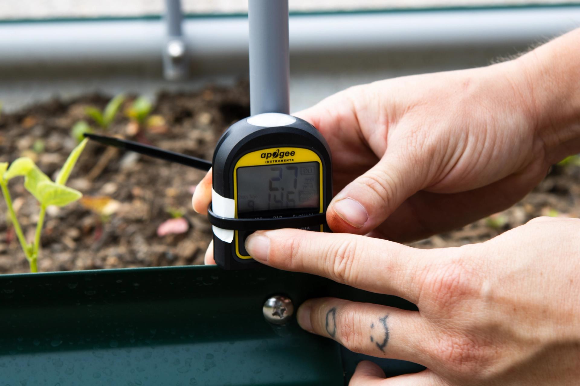 A student checks a light meter data.