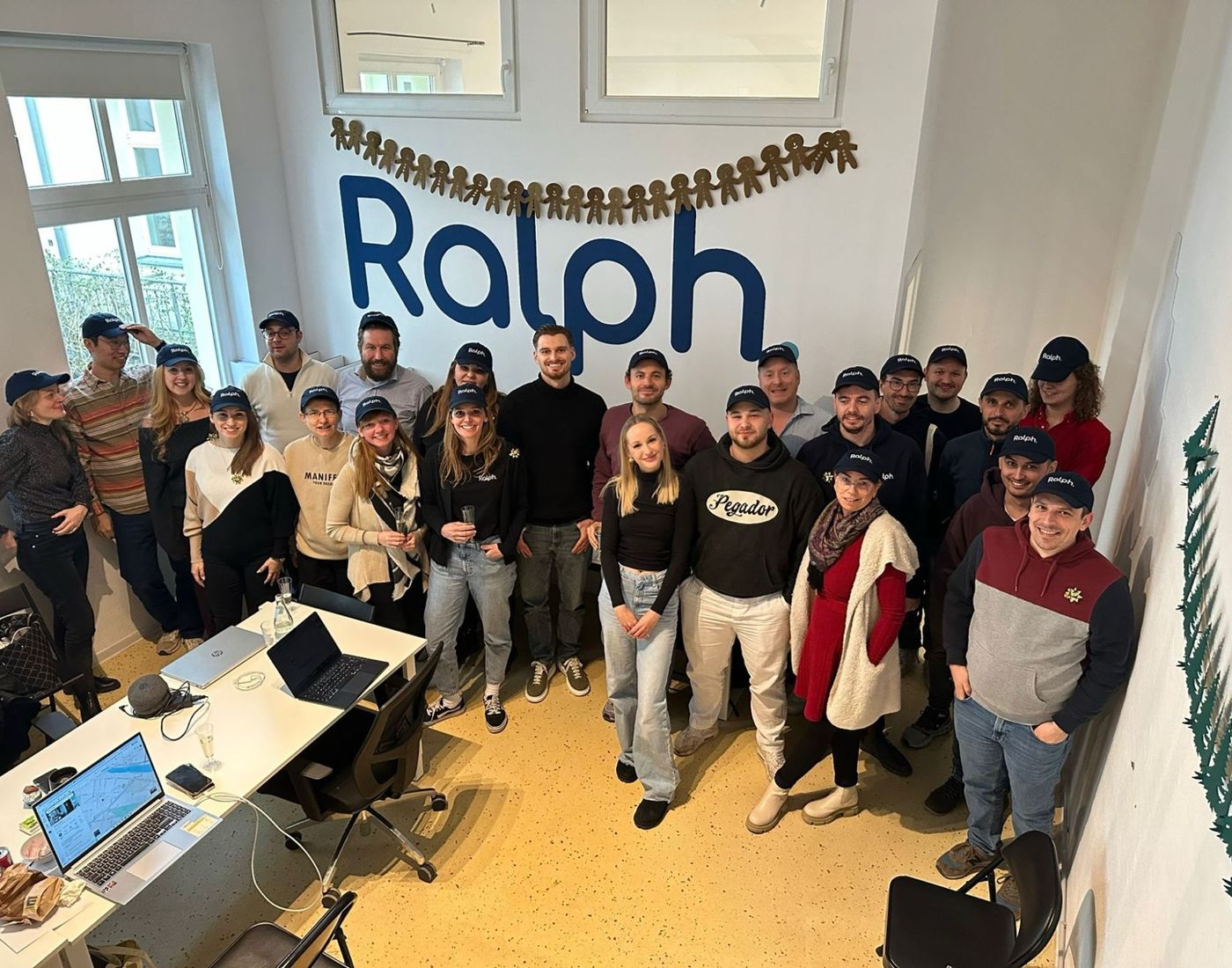 The Ralph team in the office, all wearing Ralph caps