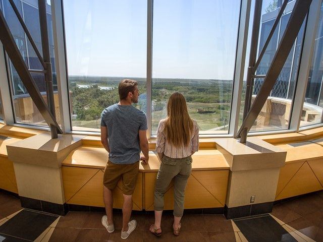 Guests looking out from the Blackfoot Crossing Historical Park Interpretive Centre.