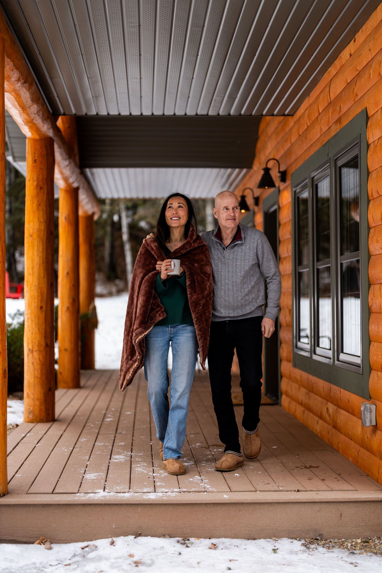 A couple walking along the veranda at the Prairie Creek Inn.