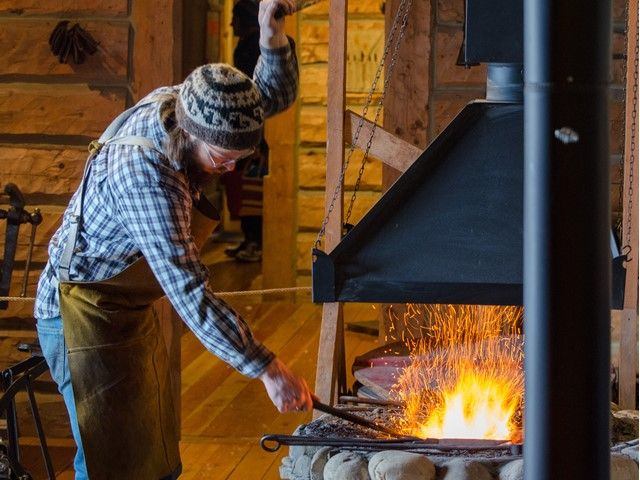 A blacksmith working at a forge.
