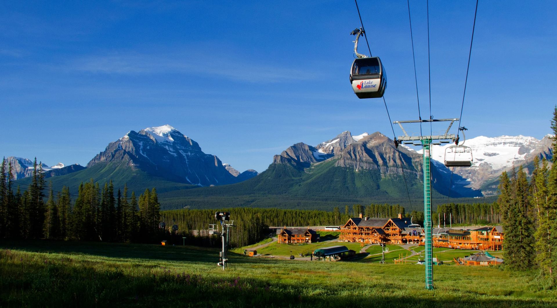 People riding the gondola at Lake Louise with Chalet in the background.
