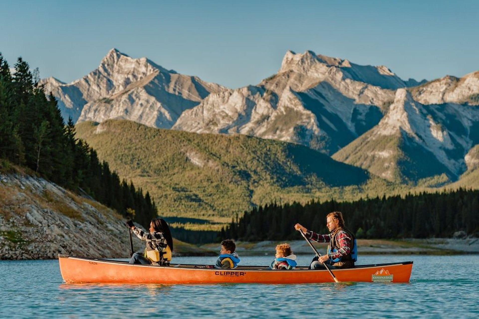 A family rowing a canoe