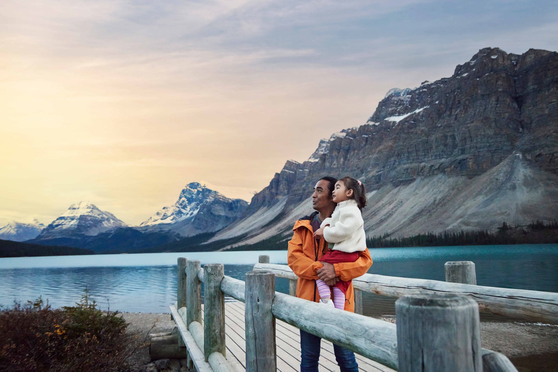 Father and daughter enjoying Bow Lake in Banff National Park.