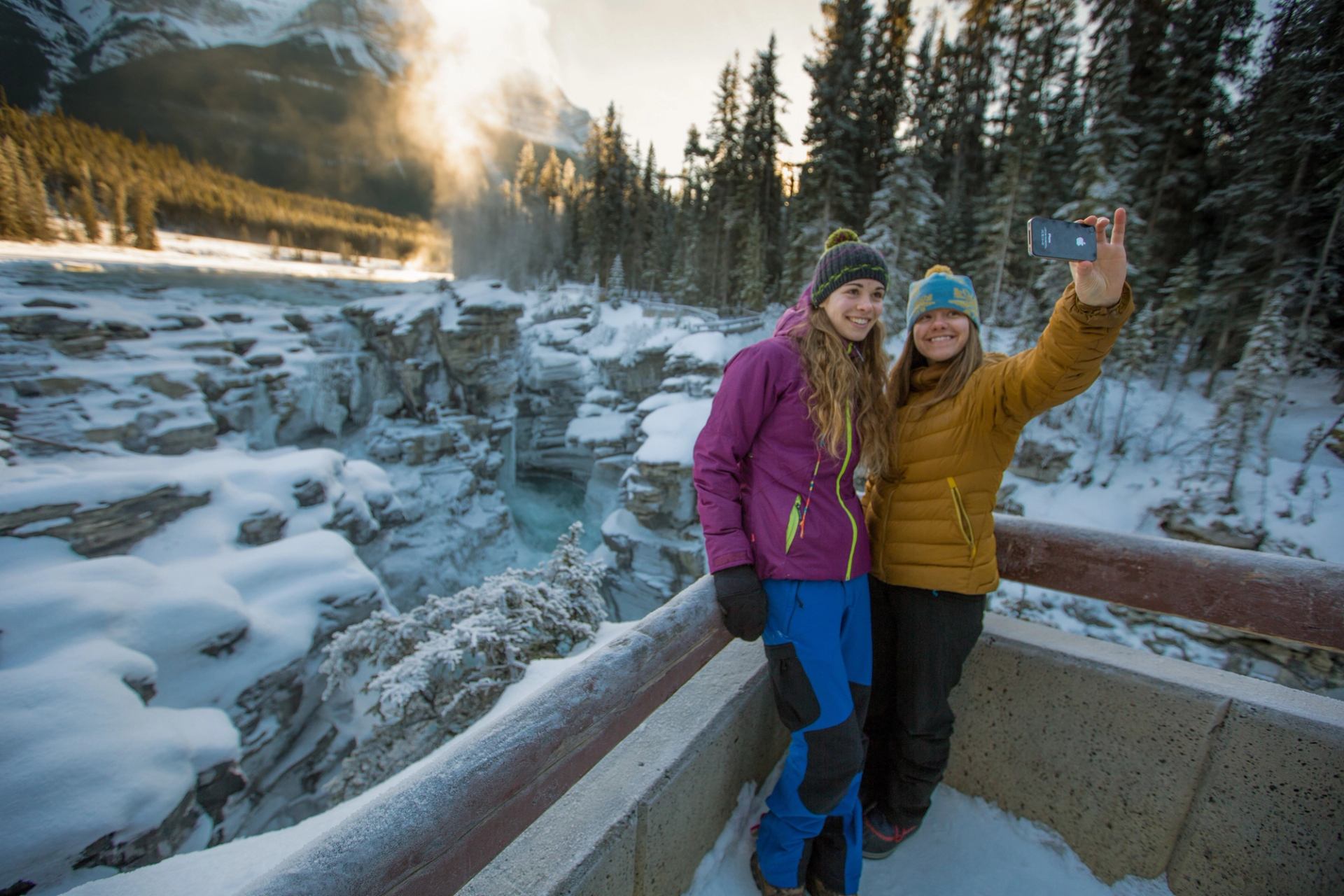 A couple of girls take a selfie at Athabasca Falls in Jasper National Park.