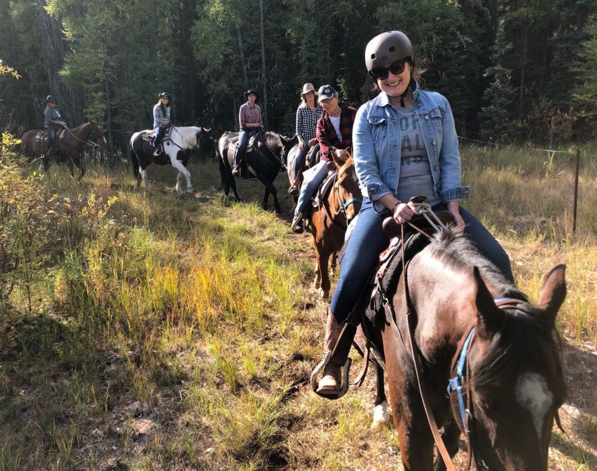 A group of people on a trail ride.