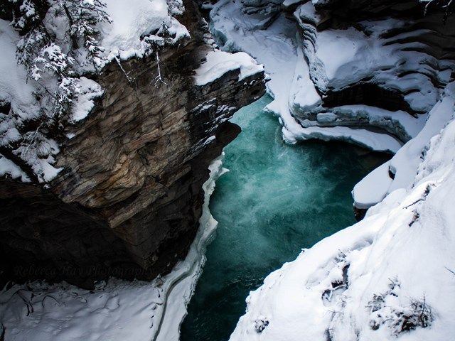 Aerial of turquoise river in winter at Athabasca Falls.