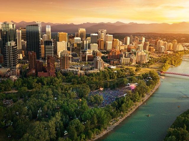 Aerial view of the city of Calgary, and a concert at Prince's Island Park.