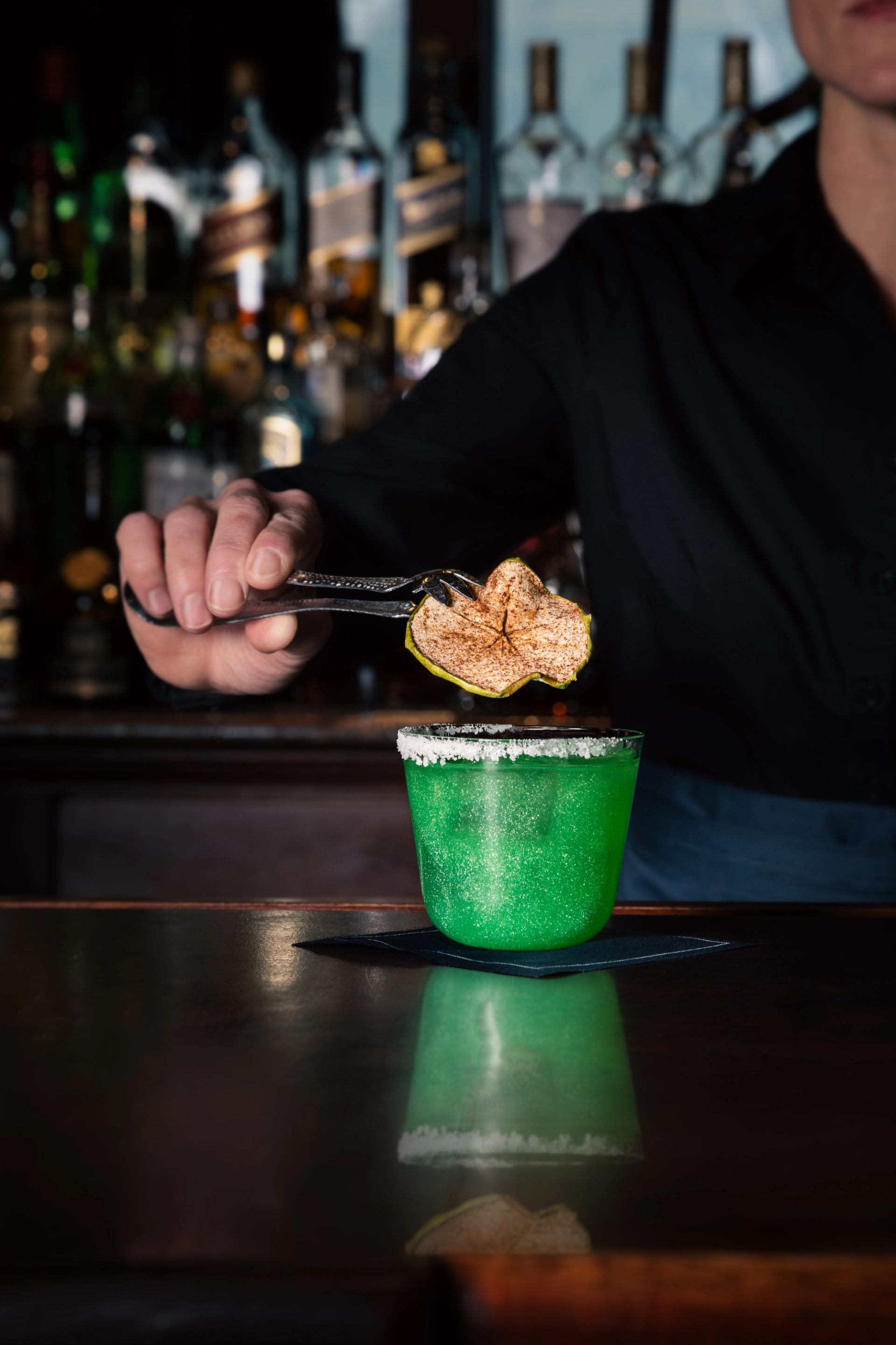 Cocktail being made at the bar in Larkspur at Rimrock Banff