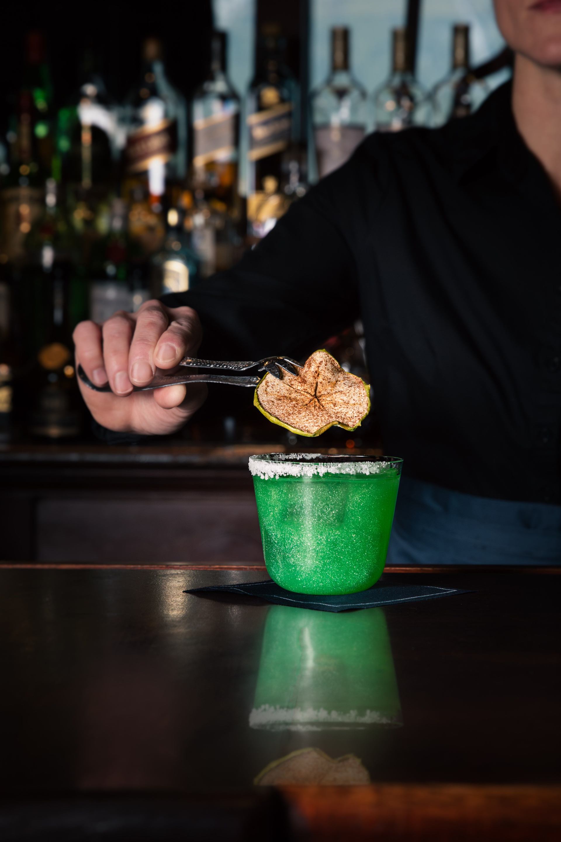 Cocktail being made at the bar in Larkspur at Rimrock Banff